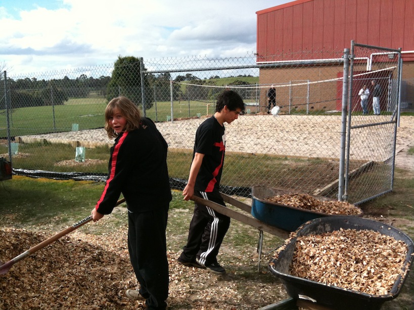 Figure 3 - HOL students putting the finishing touches on a beach volleyball court they built at their school in country Victoria